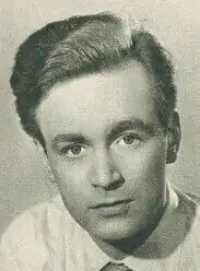 An 87-year-old man with white hair and glasses looking to the right of the camera.