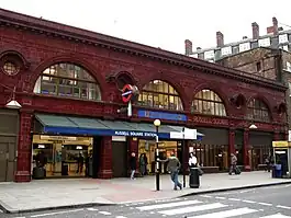 Ox-blood terracotta with semicircular windows on first floor