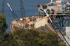 Surface and rebar: The rebar for internal shear beams may be seen on the right side just over the trees. Additional structure will connect the columns to the flyover.