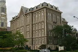 The main building of St. Ignatius College Prep in Chicago, Illinois, designed by Canadian architect Toussaint Menard, is a classic example of the style. It is one of the five extant, public buildings in Chicago that predate the Great Fire of 1871