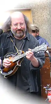 Sandy Rothman on stage, playing a mandolin