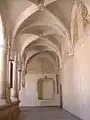 Cloister in the former monastery.  Note the restoration of the painted decoration