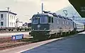 Re 6/6 11641 in its original condition leading a passenger train in the Rhône valley at Martigny.