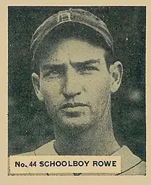 A baseball card image of a man wearing a dark baseball cap with an Old English "D" on the face