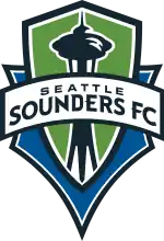 The Seattle Sounders FC crest, with the team's name on a banner stretched across a green and blue shield with the shape of the Space Needle in the center.