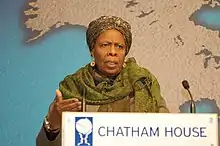 Colour photo of a woman standing behind a lectern