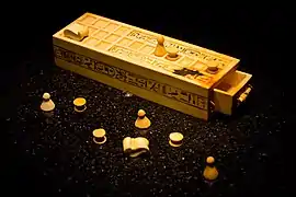 A Senet game board and game pieces from the KV62 tomb of Tutankhamun— originally from Thebes.