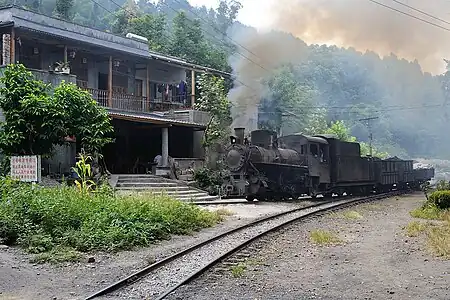 C2 07 with auxiliary train leaving Mifengyan zig zag station, 2011