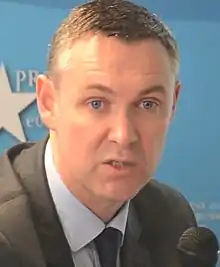 Video screenshot of Simon Hix speaking at an event in 2014