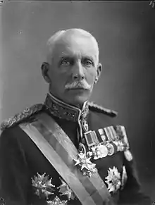 Formal head and shoulders portrait of a man in his early 60s.