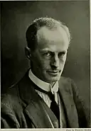 Man wearing a tie, waistcoat and jacket.