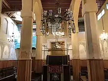 Interior of the Al Fassiyin Synagogue showing pillars and a chandelier