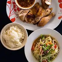 Som tam (papaya salad), khao niao (sticky rice) and kai yang (grilled chicken)