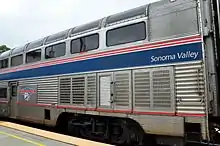 Silver double height railway car with double row of windows