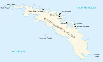  Outline of a long, narrow irregular-shaped island with small islands around its coasts. The main island is labelled "South Georgia", and various place names are shown on its north coast including Stromness Husvik and Grytviken.