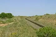 After a long climb, the BNSF railroad crosses the top of the Caprock Escarpment and extends onto the level plains of the Llano Estacado at Southland.