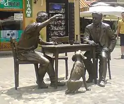 Statue of Stevan Sremac, hunter Kalča and Kalča's dog Čapa in front of the Tinkers Alley