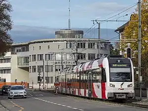 Red white striped train with coaches