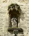 St Thomas in niche over tower door