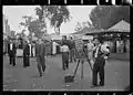 A photographer selling portrait photos in 1937.