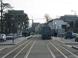 Double-track railway line in street with shelters on side platforms