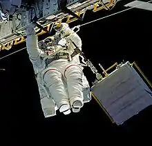 Astronaut Linda M. Godwin translates along the longeron of Atlantis' cargo bay starboard side during EVA 1.