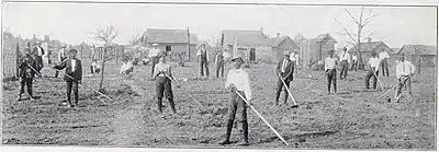 A black and white photograph of several children in a farm field