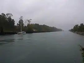 Boat passing eastward through the Sturgeon Bay Canal in stormy weather (September 2013).