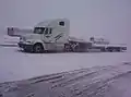 Freightliner Columbia with single drop flatbed (also known as a stepdeck) trailer