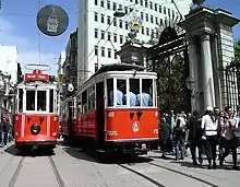 Nostalgic tram passing in front of gates of Galatasaray High School on Istiklal Caddesi in Istanbul