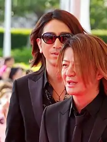 Takuro (wearing sunglasses) in 2014