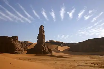 The Moul n'ga Cirque in the Tadrart Rouge region, with wave clouds above