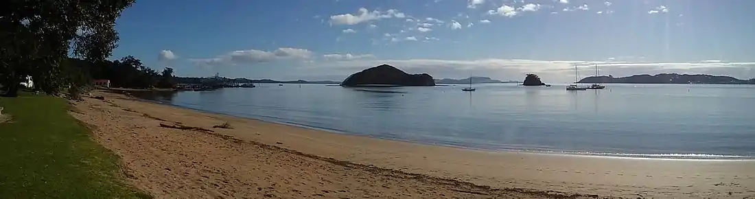 Panorama of Taiputuputu Pahi Beach looking north towards Paihia Wharf and Motumarie