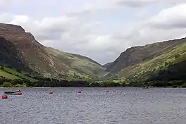 A lake, with a deep ravine between two mountains beyond