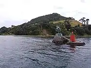 Frank Szirmay'a representation of Tangaroa in bronze with Mount Maunganui in the background