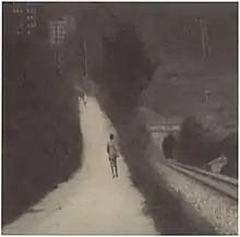 Photograph of a path in the hills, and, parallel to this, a railway line going into a tunnel. See also the adjacent text.