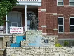 A statue of William Tell and his son sits upon a fountain outside city hall. It is a famous city landmark.