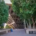 View of the building from behind mature trees