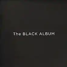 The words "The BLACK ALBUM" in a large, white font against a black background