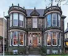 Double-fronted Victorian stone villa with large bay windows