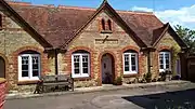 Limestone and brick almshouses in Stony Stratford, Milton Keynes. Swinfen Harris, 1892