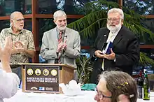 Robert Ingersoll Memorial Committee chair Jeff Ingersoll and Council for Secular Humanism CEO Ronald A. Lindsay applaud Museum director Tom Flynn, who was presented with an award for his work on the Museum. Photo by Monica Harmsen.