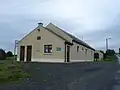 Tommy White Memorial Hall. Building started as a new church but was never finished. Later finished as a school and converted to a community centre after a new school was built.