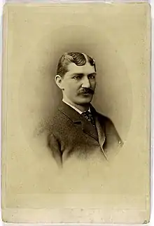 A portrait of a gentleman posing in a suit and facing slightly left.