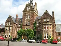 Large stone building with a clock tower on top