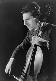 White man playing the cello, seen semi-profile