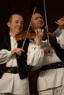 Image 83Traditional Croatian musicians playing violins (from Culture of Croatia)