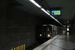 A train is arriving at the Wilshire/Western station platform