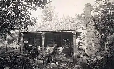 Two women in front of cabin