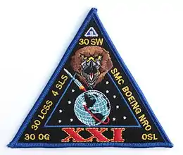 A triangular fabric patch labeled "XXI"